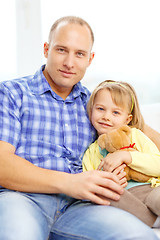 Image showing smiling father and daughter with teddy bear