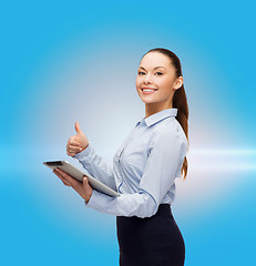 Image showing smiling woman looking at tablet pc computer