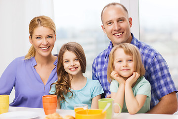 Image showing happy family with two kids with having breakfast