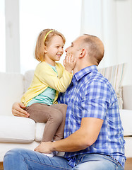 Image showing smiling father and daughter playing at home