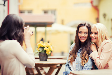 Image showing beautiful girls taking picture in cafe in city