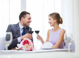 Image showing young couple with glasses of wine at restaurant