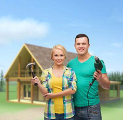 Image showing smiling couple with hammer and drill