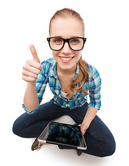 Image showing smiling woman sitiing on floor with tablet pc