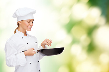 Image showing smiling female chef with pan and spoon