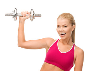 Image showing smiling woman with heavy steel dumbbell