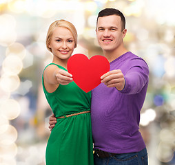 Image showing smiling couple holding big red heart