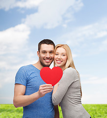 Image showing smiling couple holding big red heart