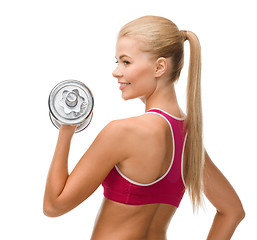 Image showing smiling woman with heavy steel dumbbell