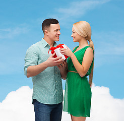 Image showing smiling couple with gift box