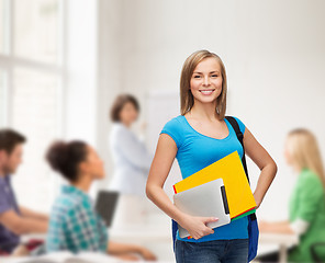 Image showing smiling student with bag, folders and tablet pc