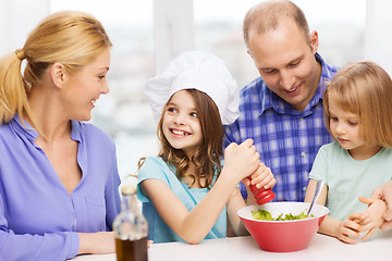 Image showing happy family with two kids eating at home