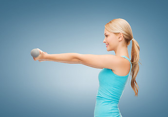 Image showing young sporty woman with light dumbbells