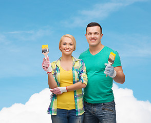 Image showing smiling couple with paintbrush