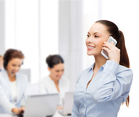 Image showing young smiling businesswoman with smartphone