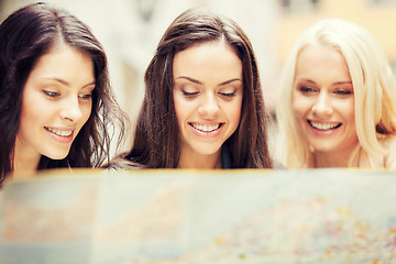 Image showing beautiful girls looking into tourist map in city