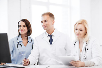 Image showing doctors looking at computer on meeting