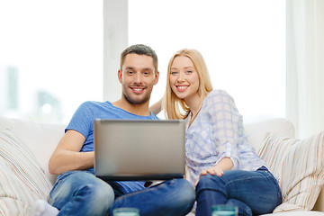 Image showing smiling happy couple with laptop at home