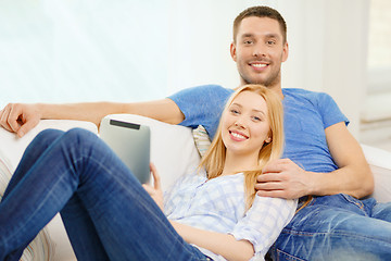 Image showing smiling happy couple with tablet pc at home