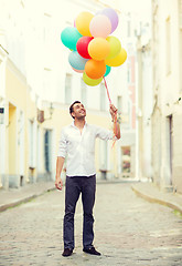 Image showing man with colorful balloons in the city