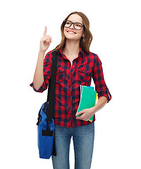 Image showing smiling female student with bag and notebooks