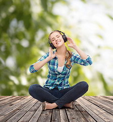 Image showing young woman listeting to music with headphones