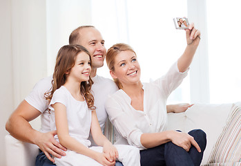 Image showing happy family with little girl making self portrait