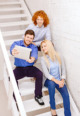Image showing team with tablet pc computer sitting on staircase