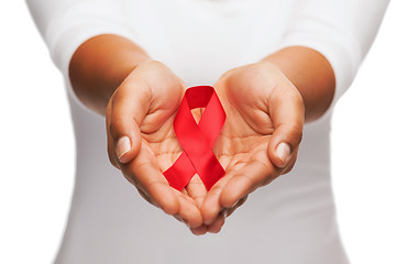 Image showing hands holding red AIDS awareness ribbon