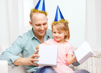 Image showing father and daughter in blue hats with gift box