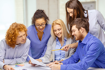 Image showing smiling team with color samples at office