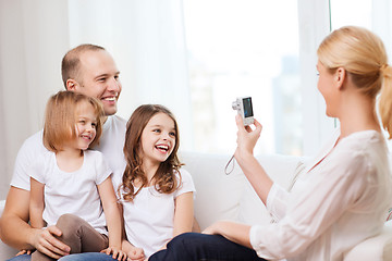 Image showing mother taking picture of father and daughters