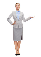 Image showing businesswoman showing something on her hand