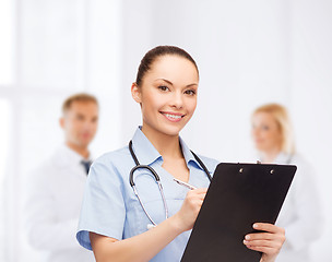Image showing smiling female doctor or nurse with stethoscope