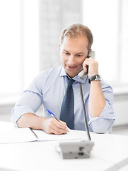 Image showing handsome businessman talking on the phone