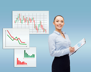 Image showing young smiling businesswoman with clipboard and pen