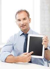 Image showing smiling businessman with tablet pc in office