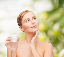 Image showing woman applying cream on her skin