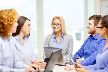 Image showing smiling team with laptop and table pc computers