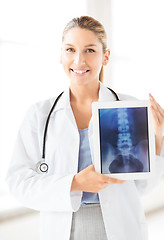 Image showing female doctor with x-ray on tablet pc