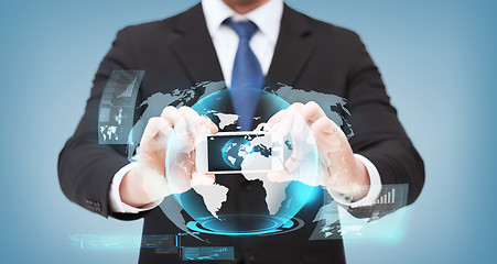 Image showing businessman showing smartphone with globe hologram