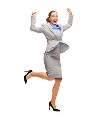 Image showing happy woman jumping with hands up