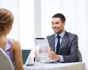 Image showing man with tablet pc looking at wife or girlfriend