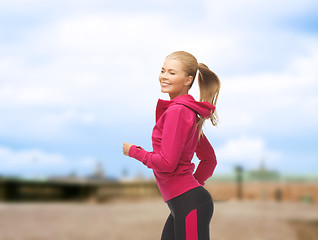 Image showing sporty woman running or jumping