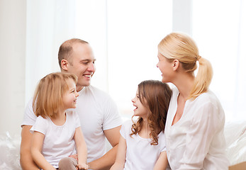 Image showing smiling family with two little girls at home