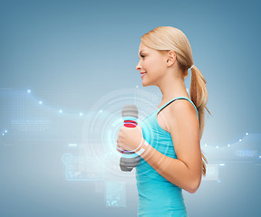 Image showing young sporty woman with light dumbbells