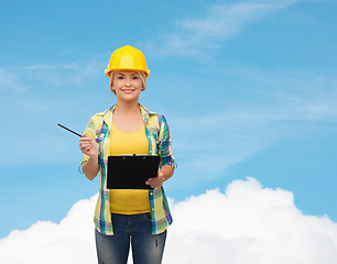 Image showing smiling woman in helmet with clipboard