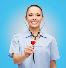 Image showing smiling female doctor or nurse with stethoscope