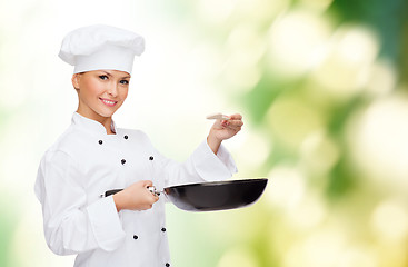 Image showing smiling female chef with pan and spoon