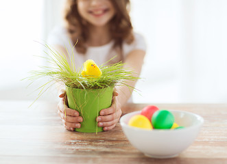 Image showing close up of girl holding pot with green grass